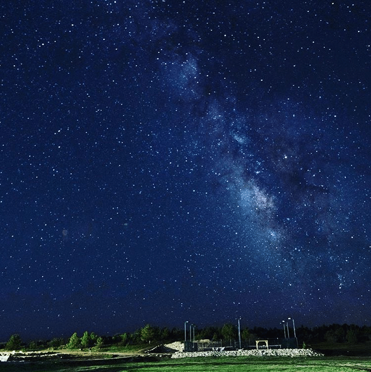 A star-filled night sky with the Milky Way visible.